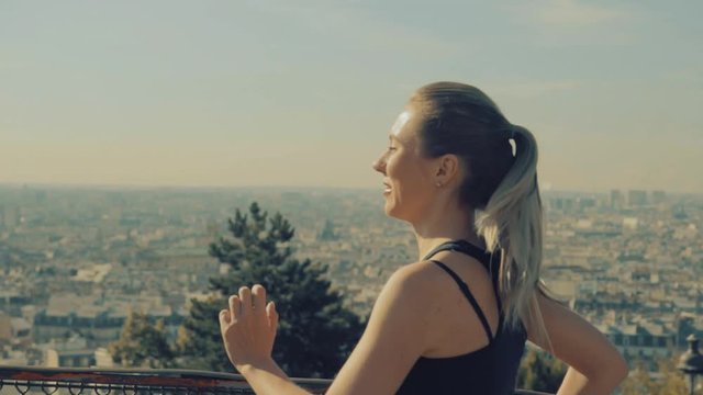 Woman running. Morning runner on the street with beautiful city view in Paris under sunlight.