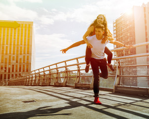 Young couple having fun and walking in the city urban outdoor