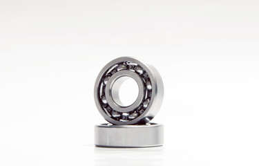 two metal bearings on the white