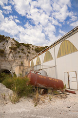 Old oil tanks in a dilapidated mine