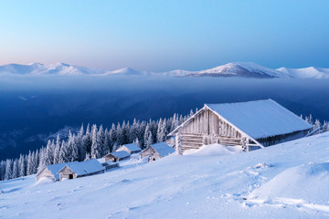 Snowy cabin in the winter mountains