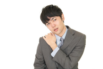 肩こりを訴えるビジネスマン