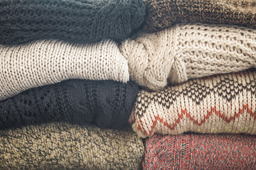 a stack of knitted sweaters