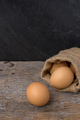 eggs from brown sack on wood table