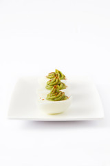 Stuffed eggs with guacamole isolated on white background

