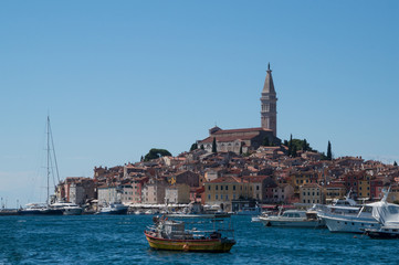 Rovinj, Croatia: 22.07.2017 - Ship leaving the Rovinj harbor with the town in the background