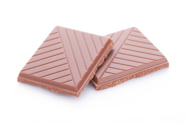 Slices of milk chocolate isolated on white background
