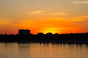 Orange sunset over a river Dnieper in Kremenchug city, Ukraine