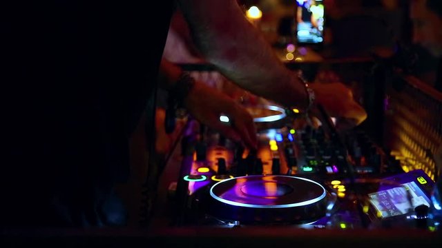 Dj playing and mixing music in a night club