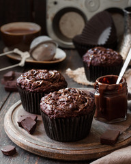 chocolate muffins on a wooden background