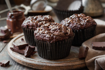 chocolate muffins on a wooden background