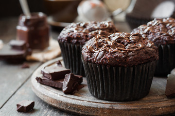 chocolate muffins on a wooden background