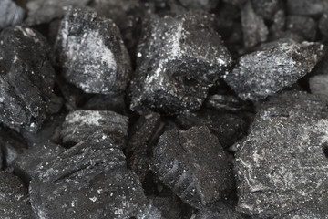 Burnt charcoal texture background. Selective focus