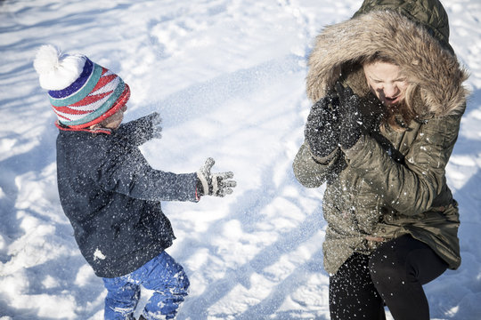 Mother playing with son in snow