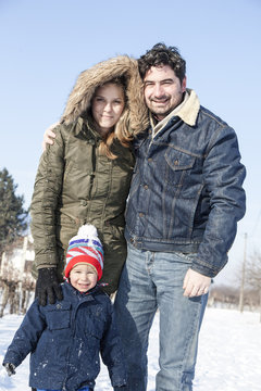 Parents with boy in snowy landscape