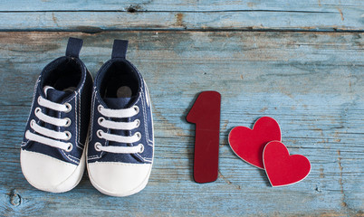 Baby shoes on wooden background