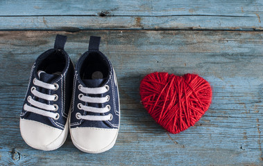 Baby shoes on wooden background