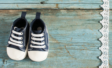 Baby shoes on wooden background