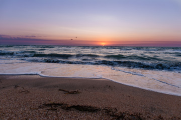 Sunrise near the sea beach with blue waves