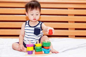 Baby boy playing with wooden blocks