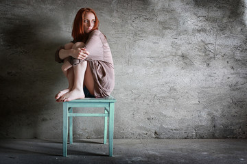 Cute girl in a studio with grange background © alexkich