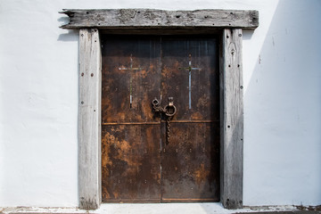 Large metal door framed in solid timber