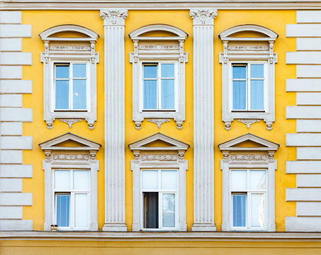 Facade of antique historical building. Windows with decorative stucco elements. Lviv, Ukraine. European travel photo.