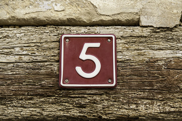 Number five of information on the wall of a house