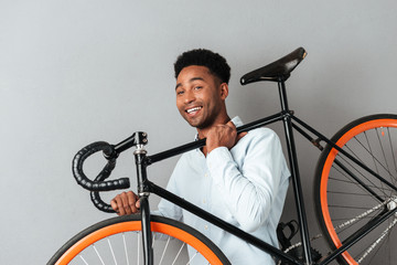 Happy african man with bicycle