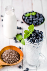 Chia pudding with berries and milk, sweet nourishing dessert, healthy breakfast superfood concept