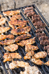 Flat lay above chicken white breast meat on the barbecue grill with kebabs