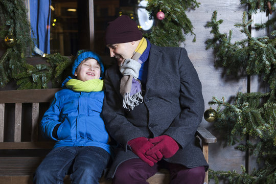 Grandfather and grandson sitting on bench, Bad Toelz, Bavaria, Germany
