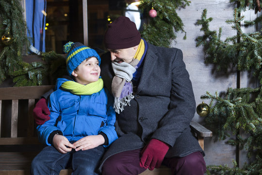 Grandfather and grandson sitting on bench, Bad Toelz, Bavaria, Germany