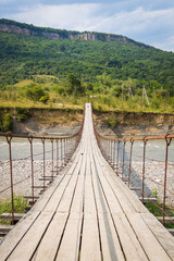 Suspension cable bridge, Crossing the river. Adygea republic, Krasnodar region, Russia