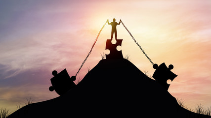 silhouette  people pull jigsaw with chain on top of mountain, concept as strength, effort and intent to build and improve to success in business © khwanchai