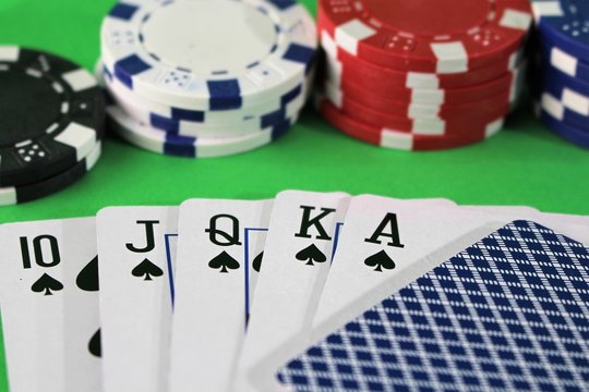 An image of a royal flah - poker, chips