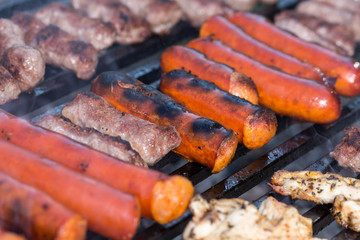 Flat lay above minced meat kebabs frying on the barbecue grill