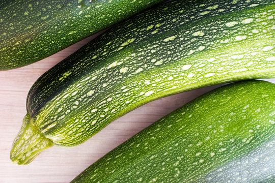 Green zucchini on wooden table