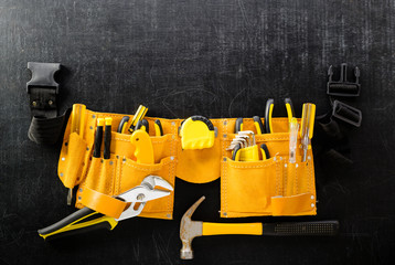set of tools in toolbelt tape measure nippers. Concept of DIY and manual work