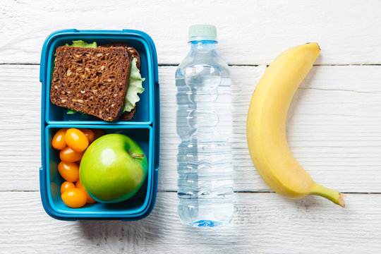 Photo of fitness breakfast in box, bottle of water