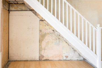 Old bare wall and stairs during renovations.