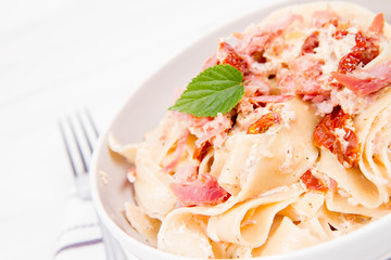 Pappardelle with cream, sun-dried tomatoes and smoked fish