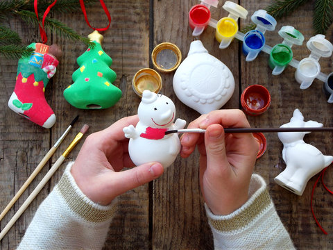 Painting toys for Christmas decorations from porcelain with your own hands. Children's DIY concept. Making xmas tree decoration