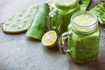 Cactus smoothie. Healthy nopales, aloe vera and lemon detox drink in jars and ingredients