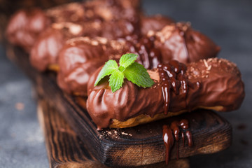 Chocolate eclair decorated with mint and melted chocolate