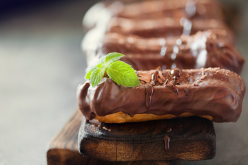 Chocolate eclair decorated with mint and melted chocolate