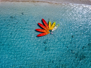 Canoe and kayaks like flower in Polynesia Cook Island tropical paradise aerial view