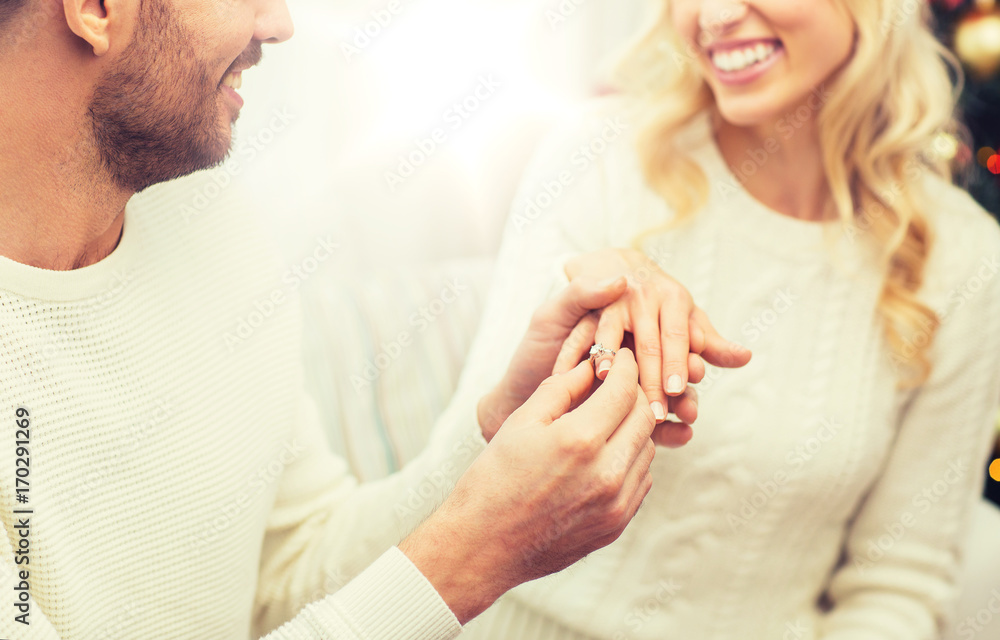 Poster man giving diamond ring to woman for christmas