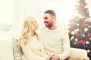 happy couple at home with christmas tree