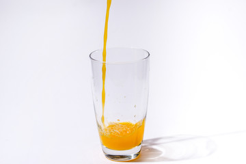 splashing orange juice with oranges against white background By showcake